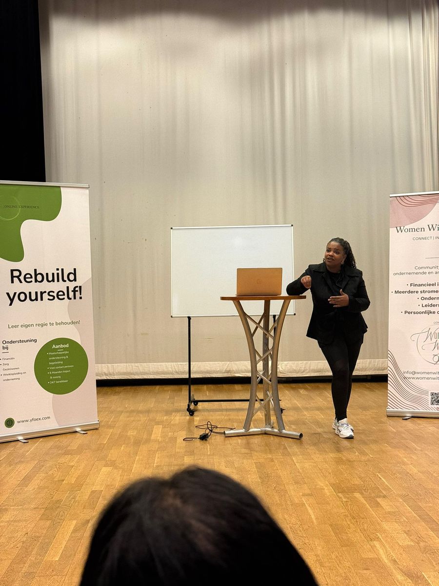 A workshop leader presenting on stage